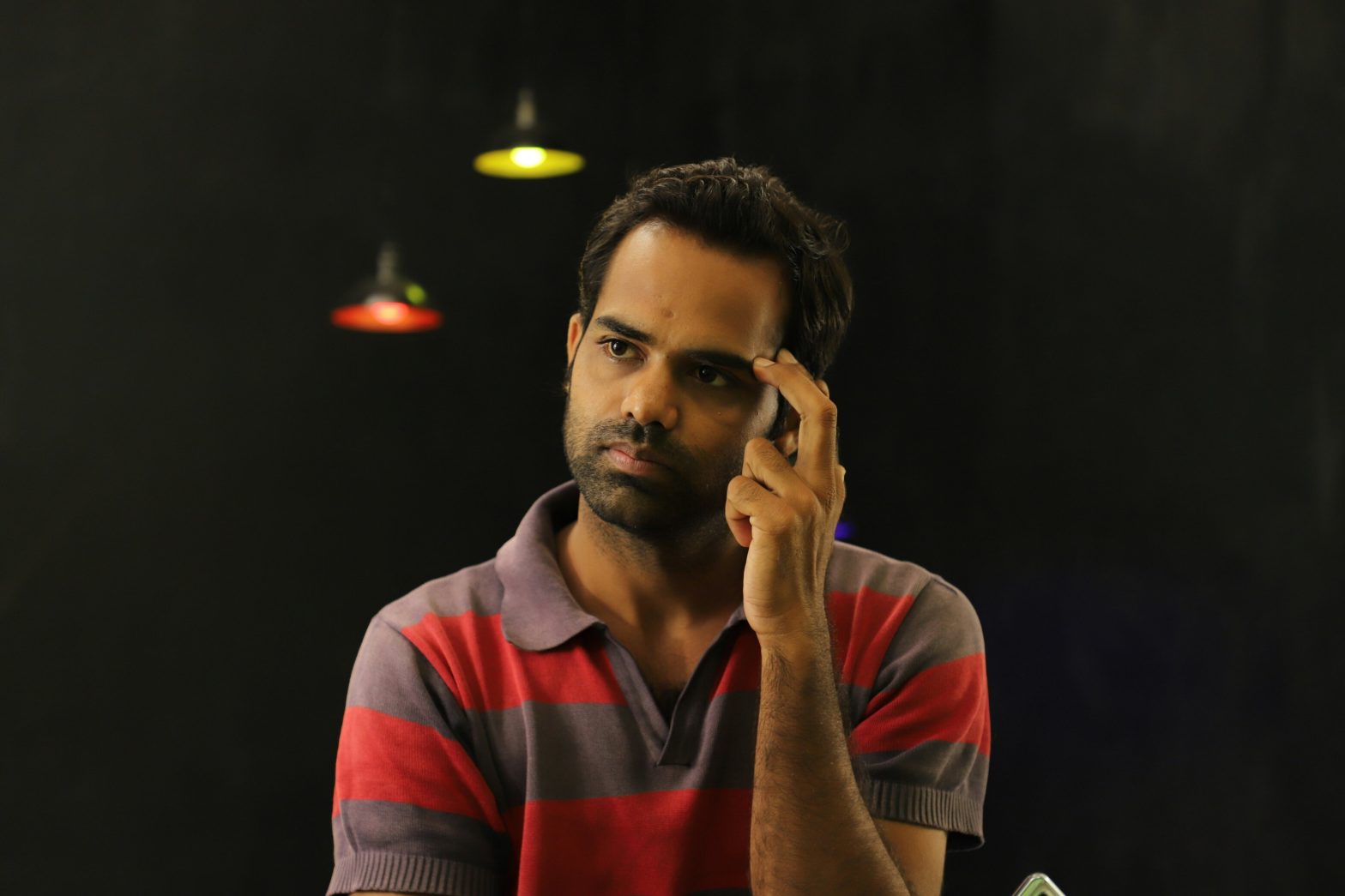 An image of a man scratching his head and thinking.